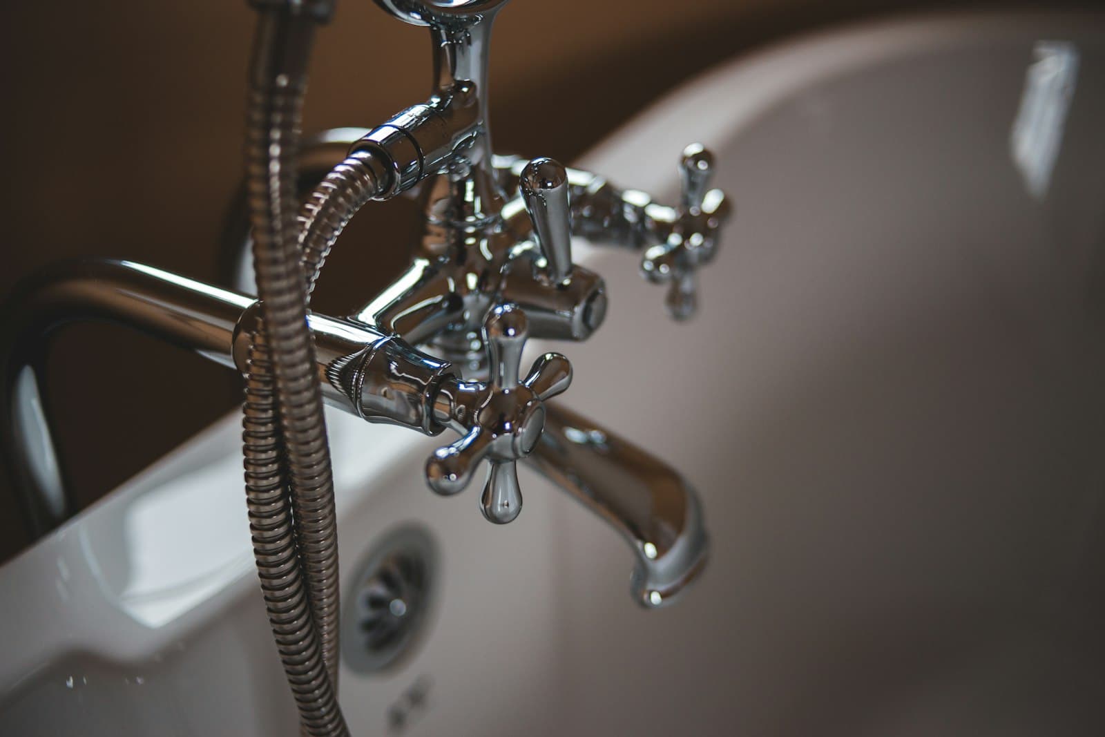 A chrome tap and bath, water arriving at the premises